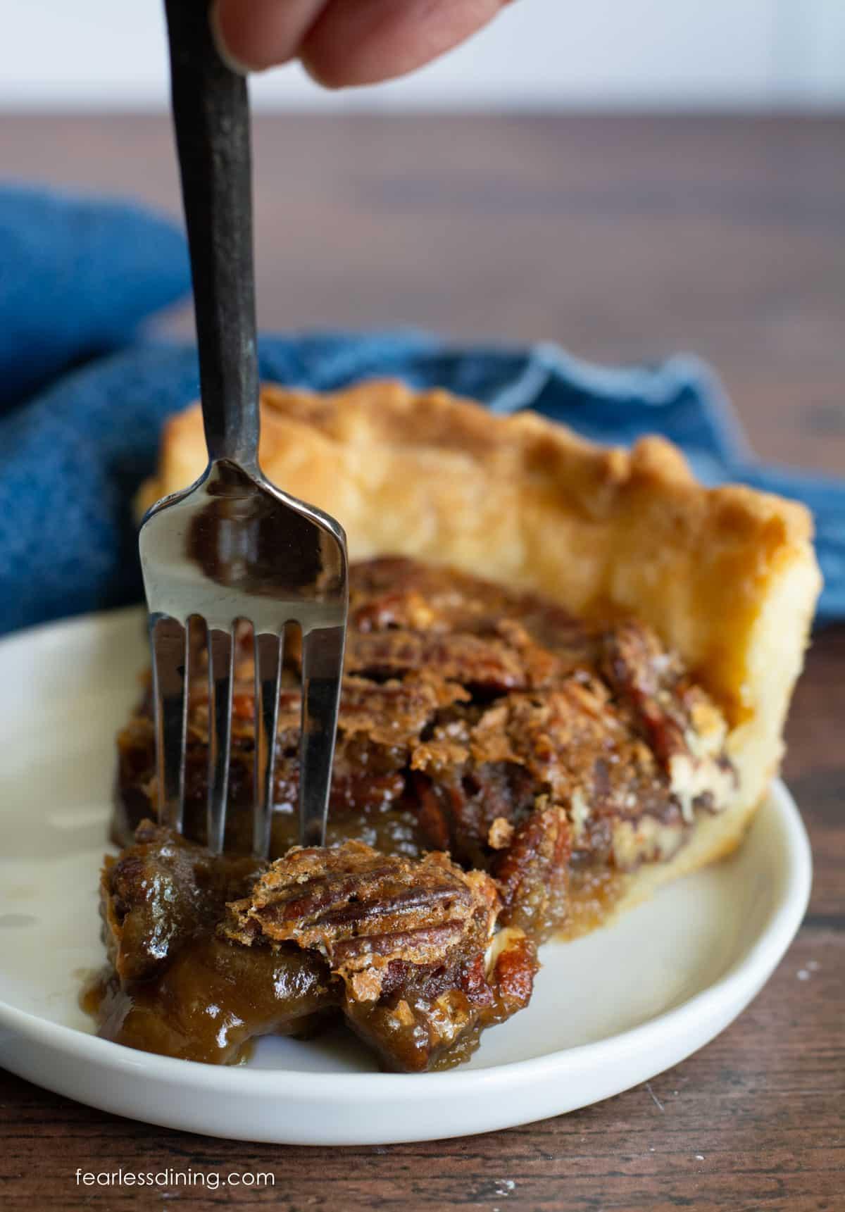 Slice of pecan biscuit bake on a plate with a fork