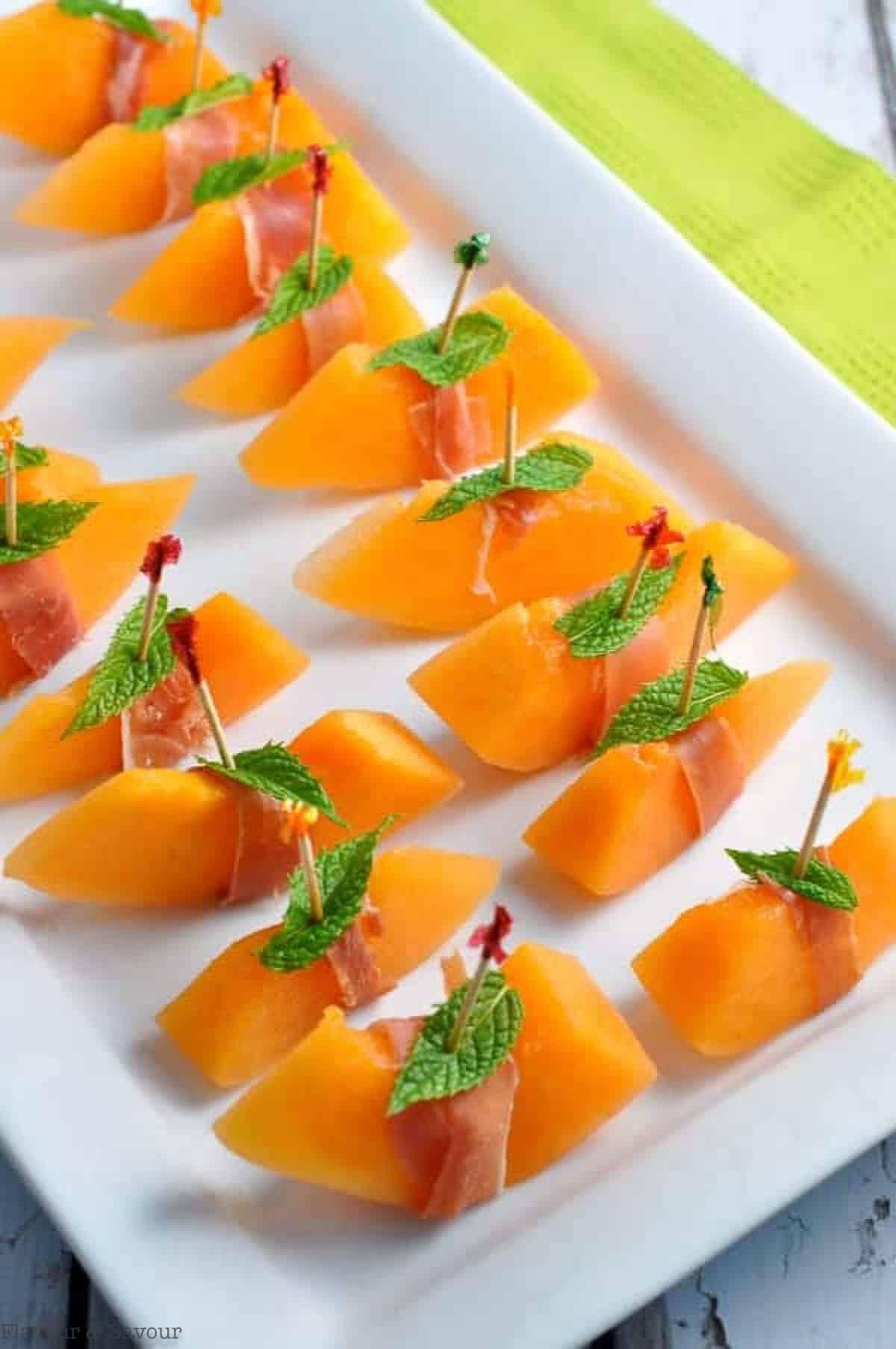 ingredients for prosciutto wrapped melon, cantaloupe, prosciutto, mint