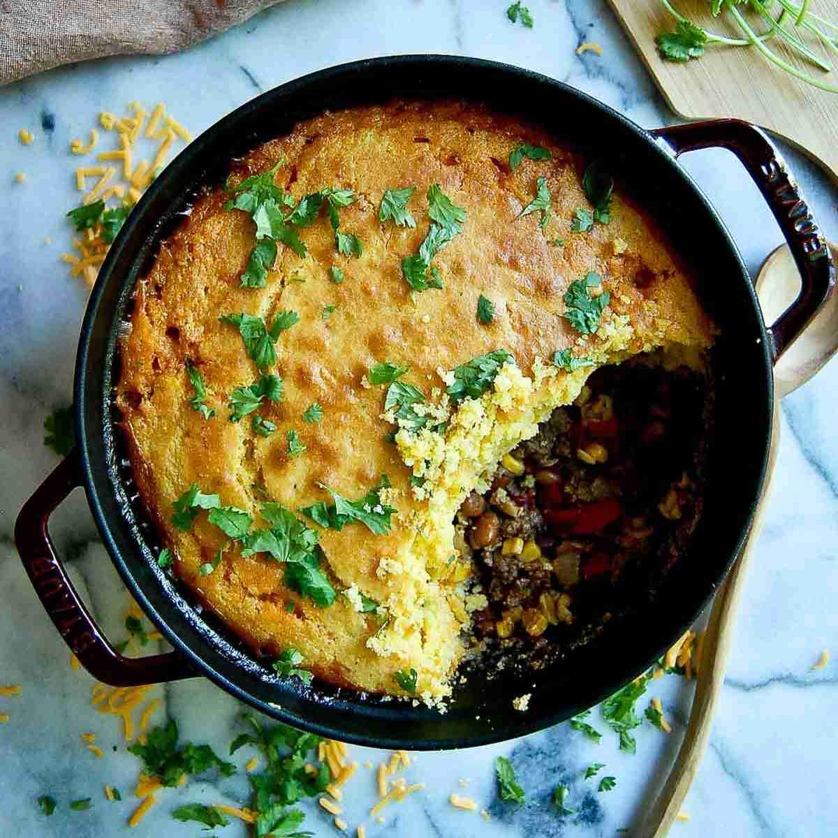 Hearty cowboy casserole with beef, corn, and cheesy topping, fresh from oven