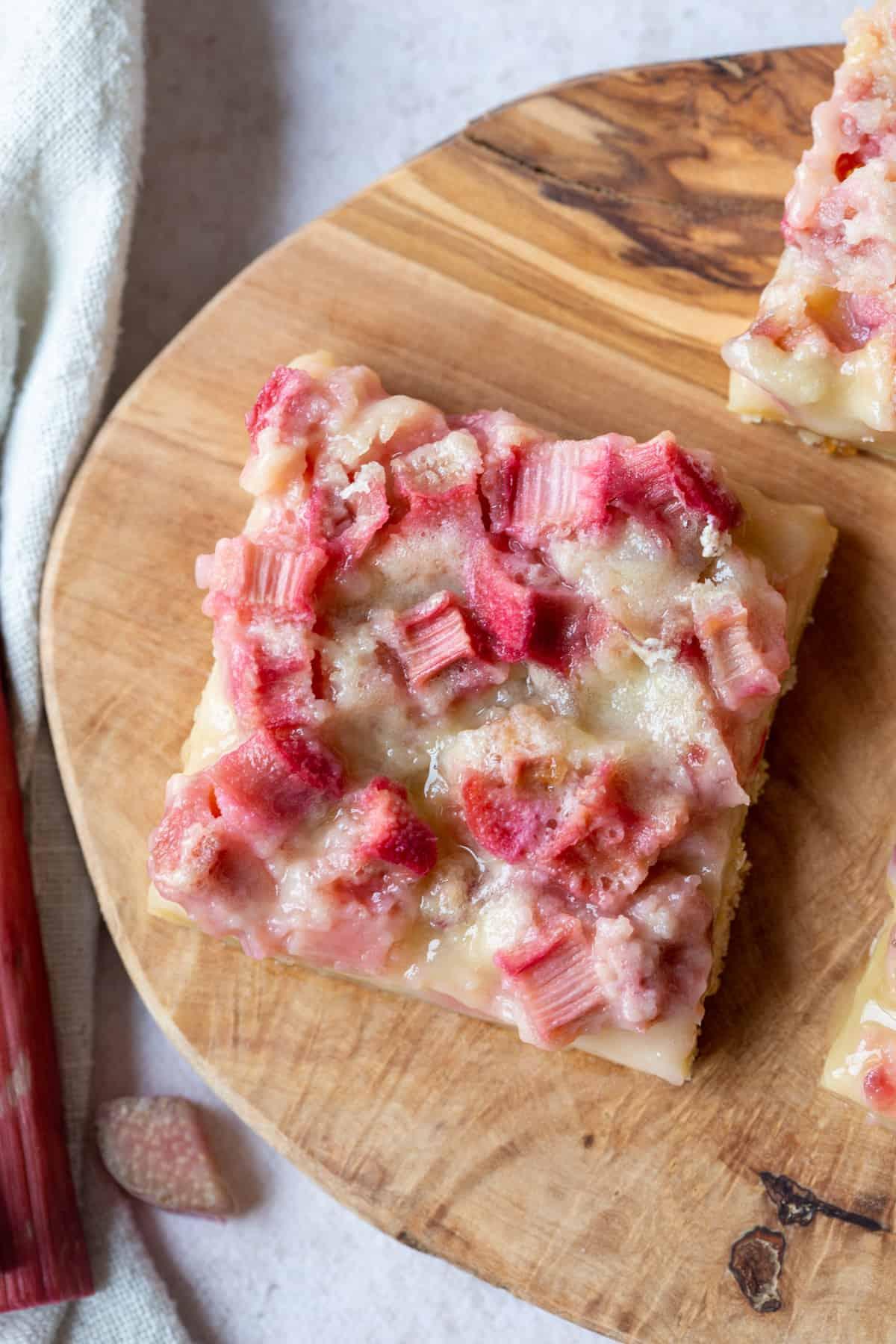 Macadamia Crust Rhubarb Custard Bars on a wooden cutting board