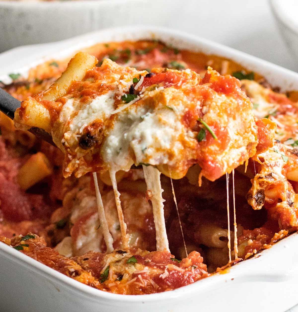 Close-up of baked ziti showing melted cheese and pasta layers, ready to be served