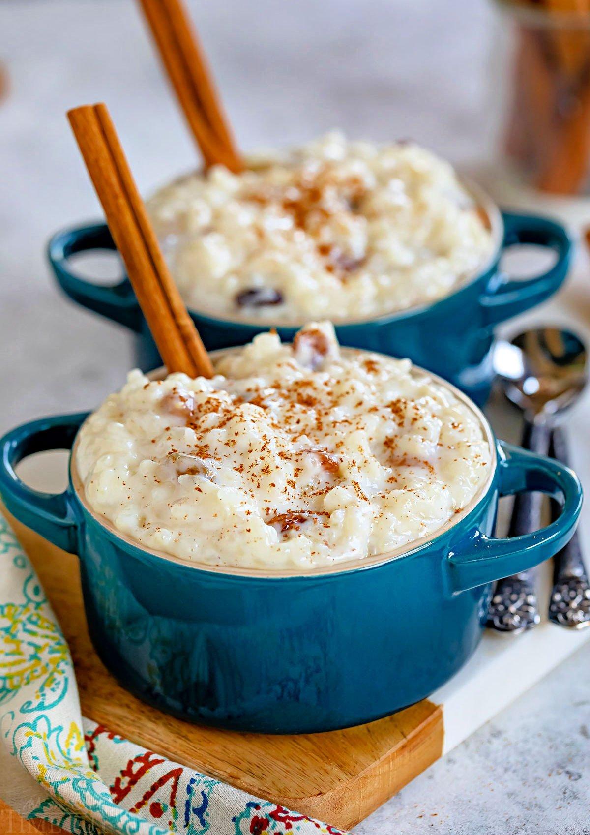 Hand garnishing baked rice pudding with cinnamon and a few raisins