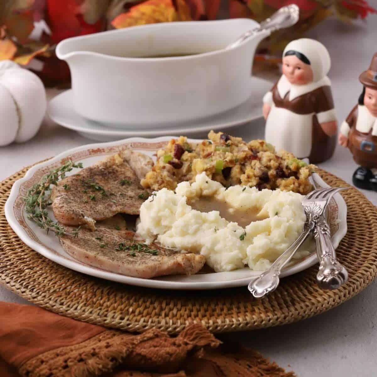 plate of golden turkey cutlets with a side salad and mashed potatoes
