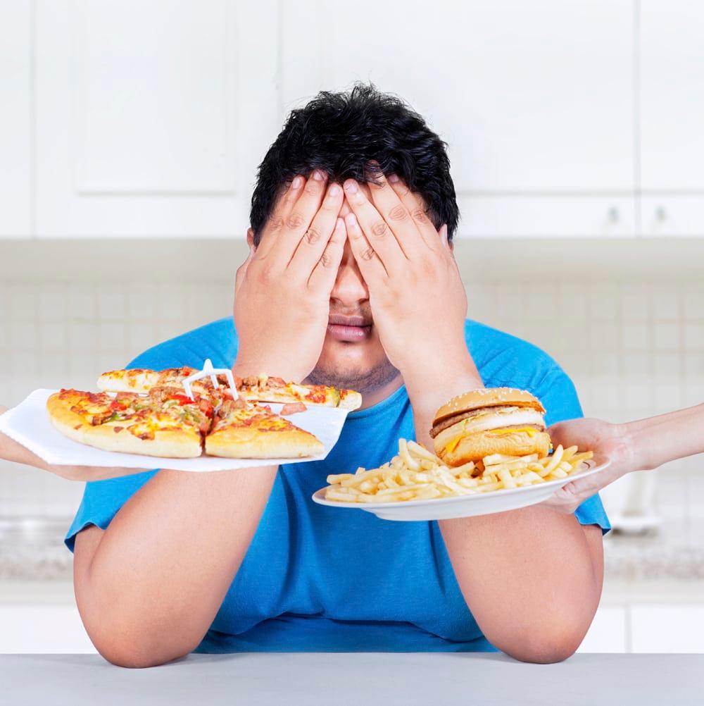 person regretting eating unhealthy food