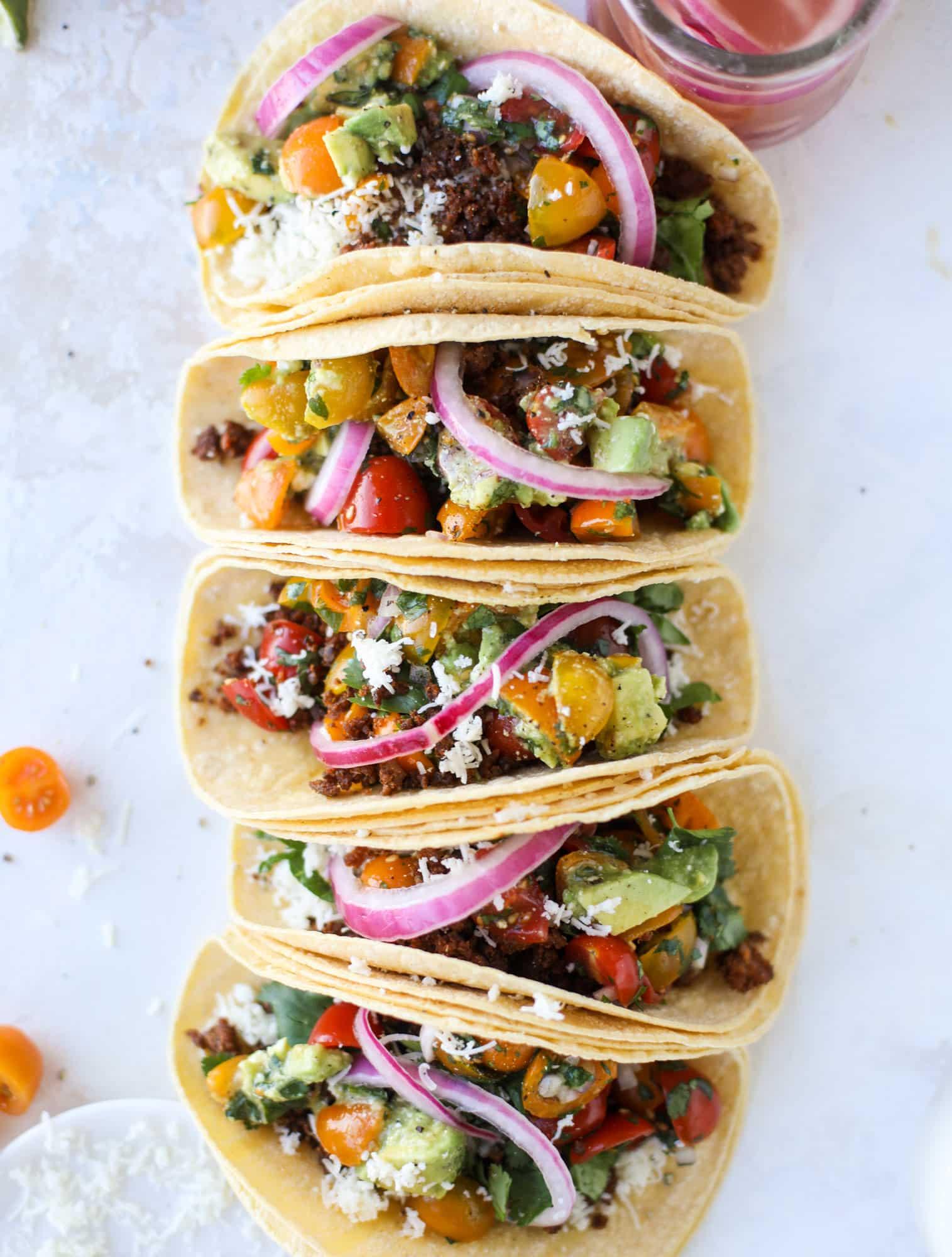 group of people eating and enjoying ground beef tacos