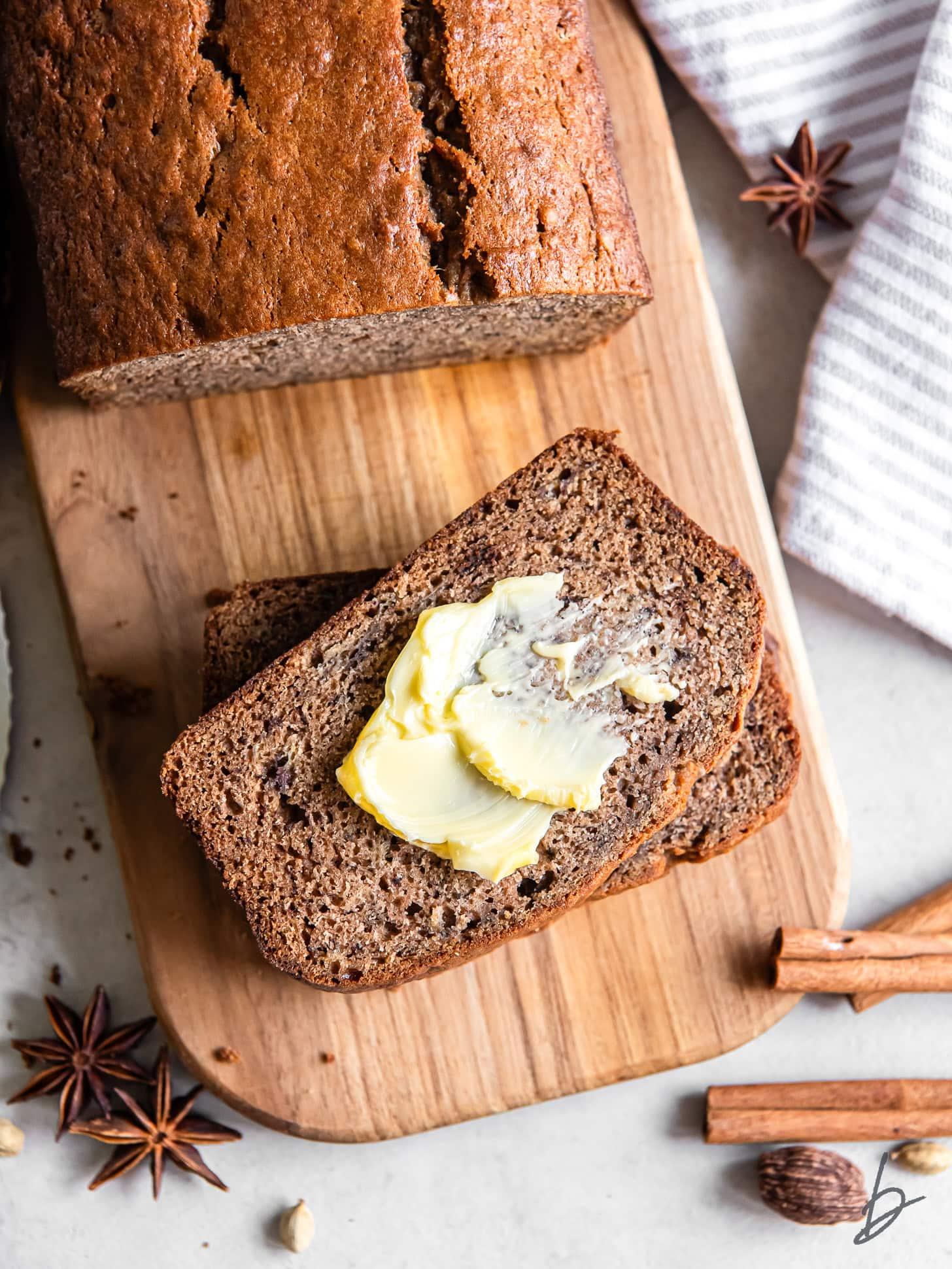 freshly baked banana spice sugar bread loaf on a wooden cutting board, cozy kitchen setting, autumn spices
