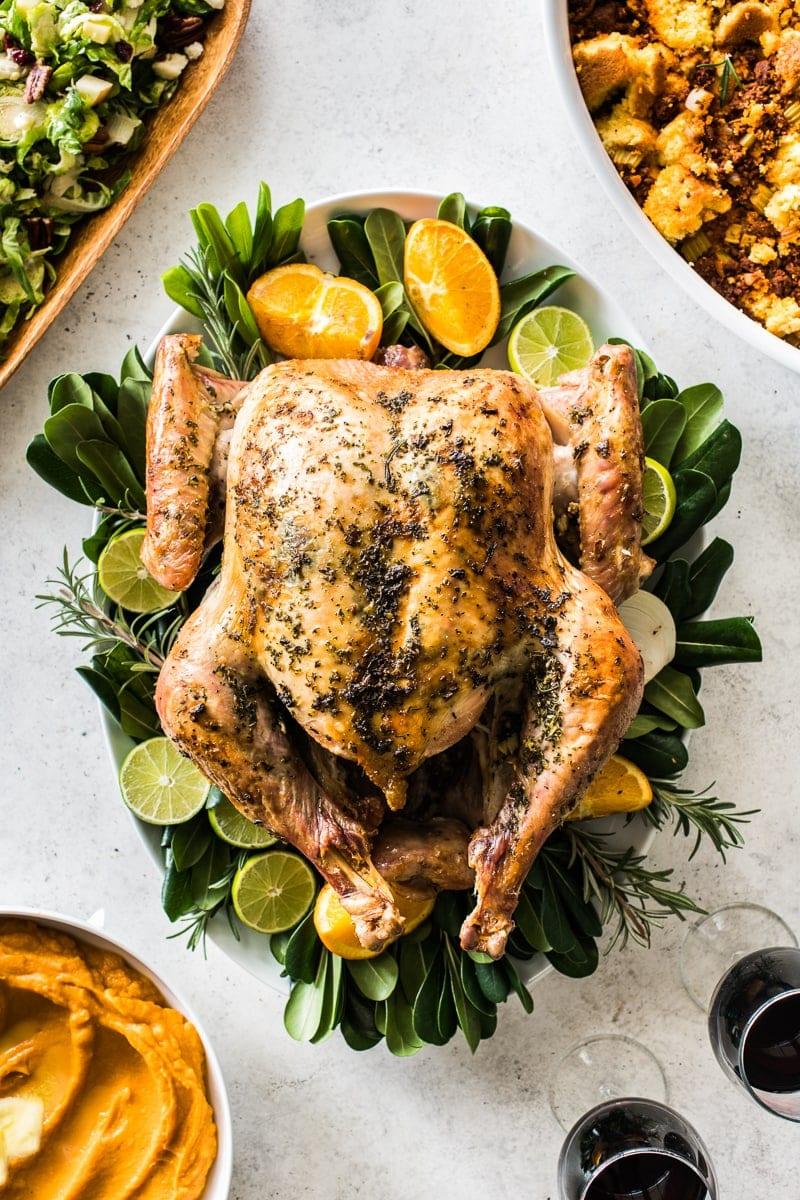 honey thyme roasted turkey, golden brown, succulent, soft texture, garnished with fresh thyme sprigs