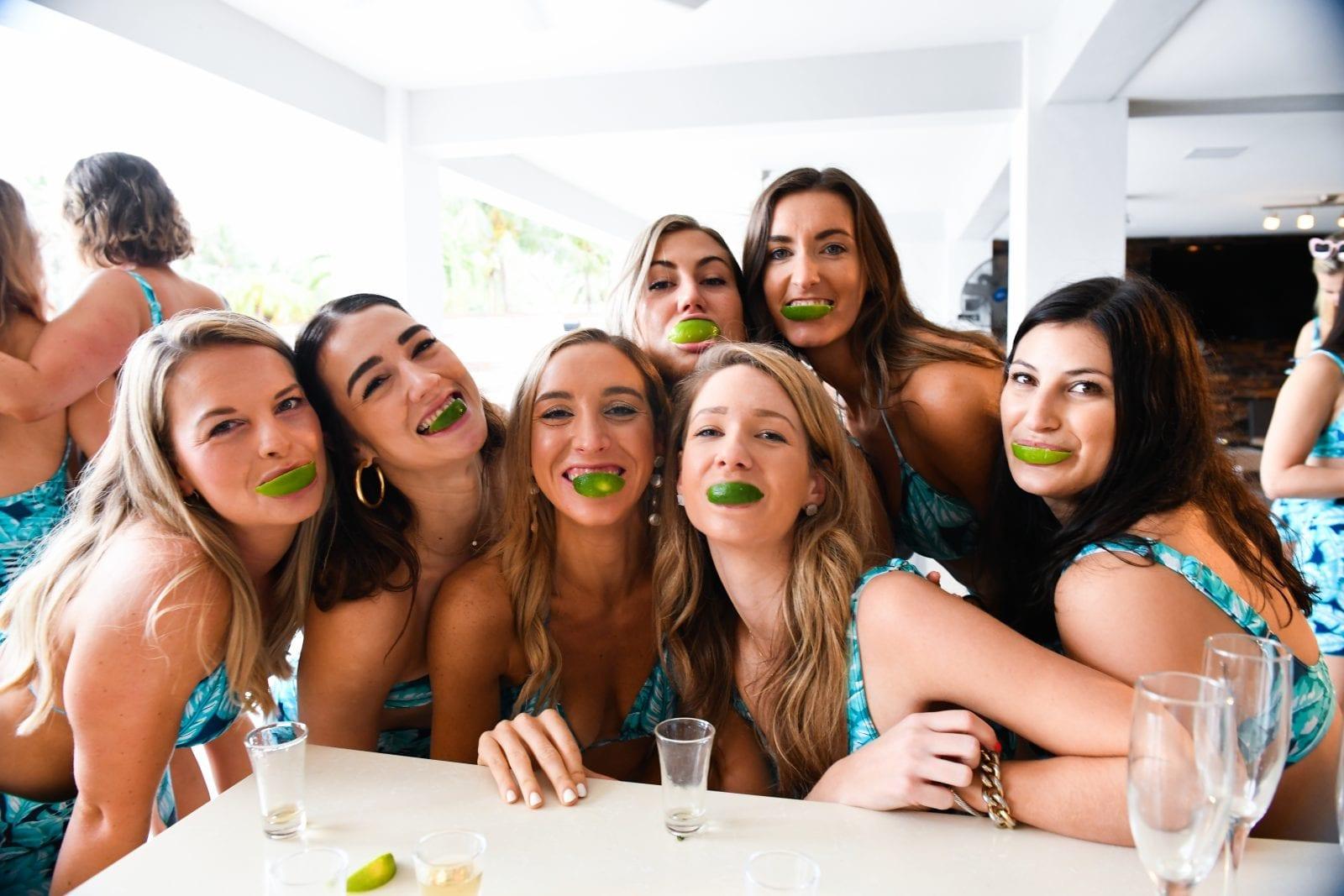 woman sharing travel cocktail recipe with friends at a party