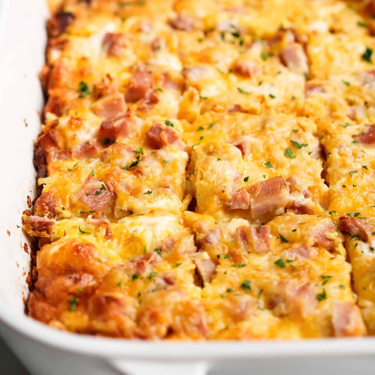 golden hash brown egg casserole with melted cheese and fresh herbs, cozy morning light