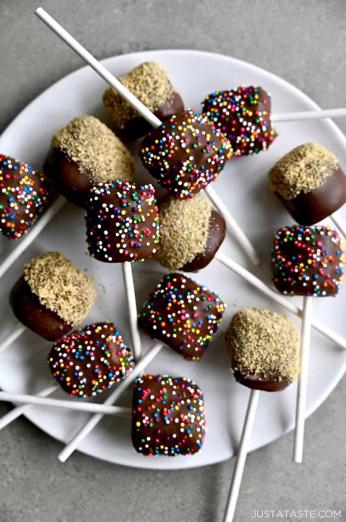 Close-up, decadent chocolate dipped marshmallows with sprinkles on a cooling rack
