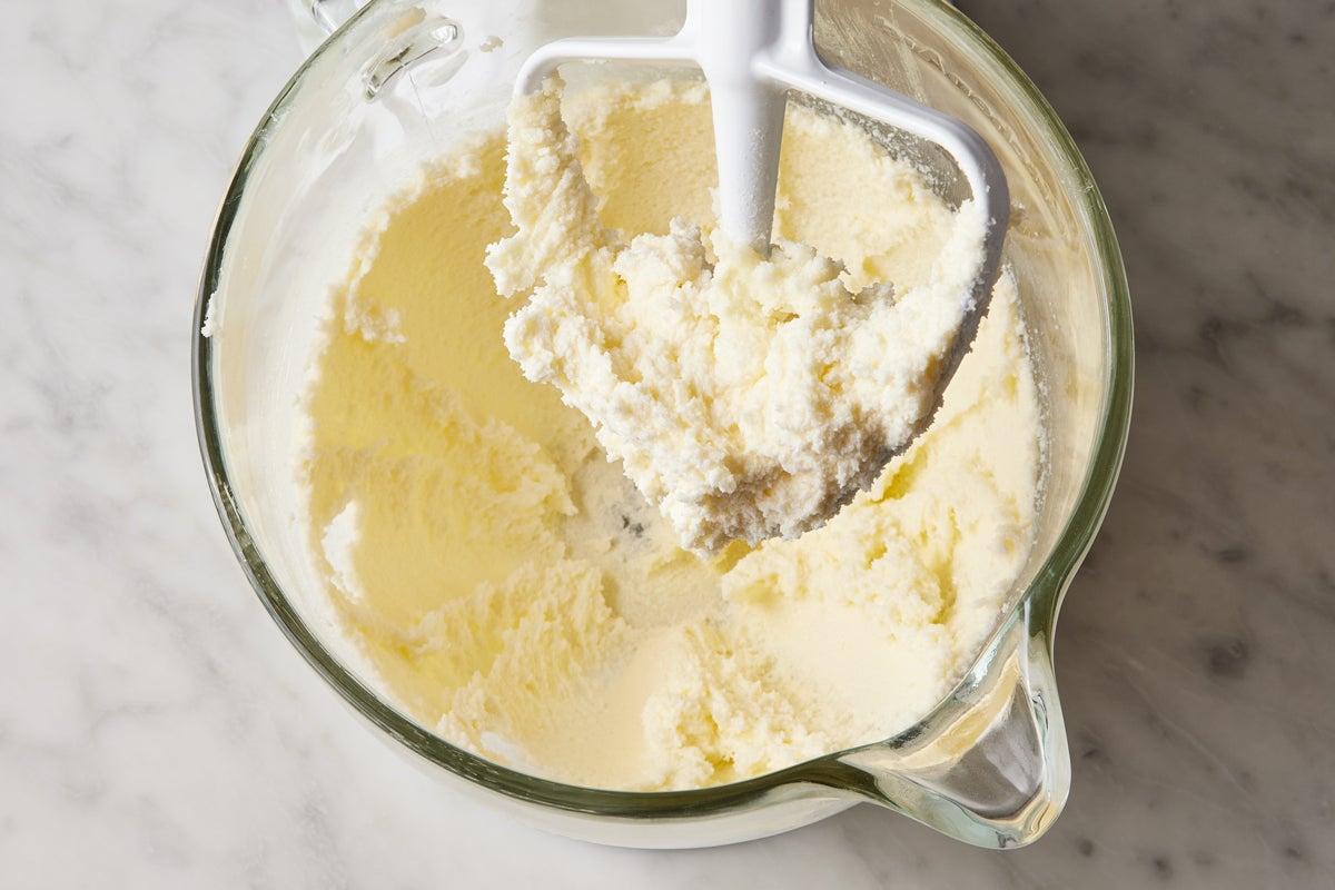 Close-up shot of creamy butter and sugar being mixed in a bowl