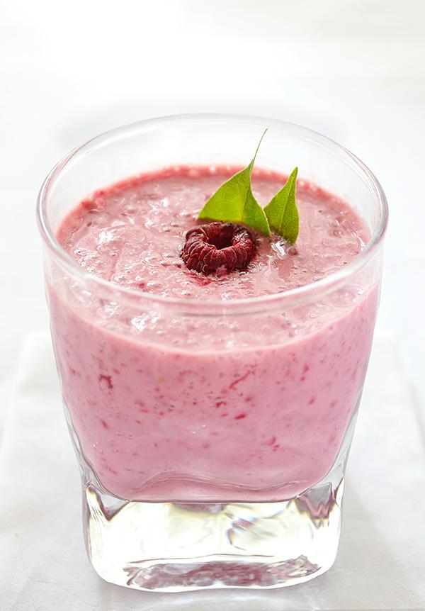 Ingredients for raspberry mint lassi arranged on a table