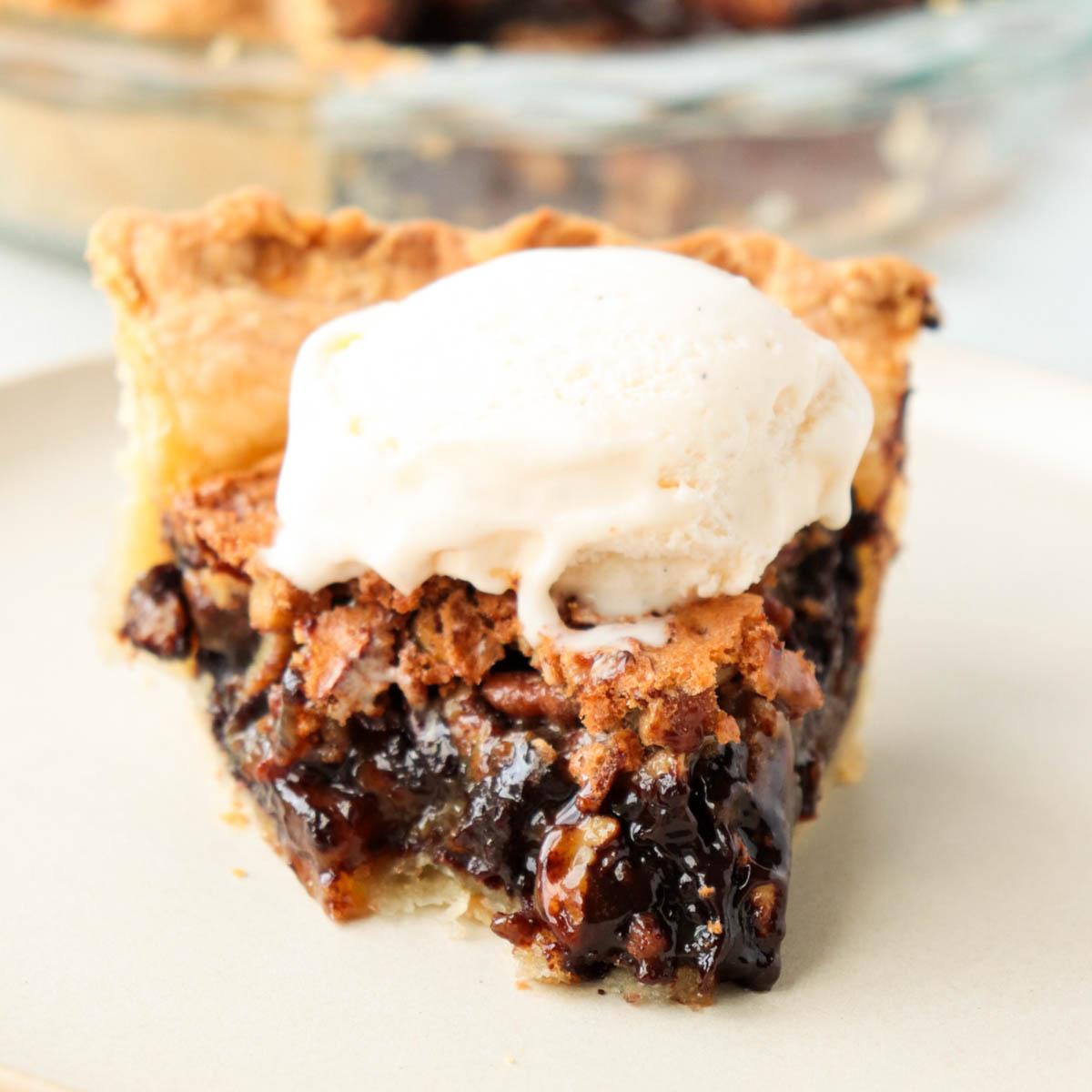 slice of rich chocolate pecan pie with fudgy center, golden crust, a scoop of vanilla ice cream melting slightly on top