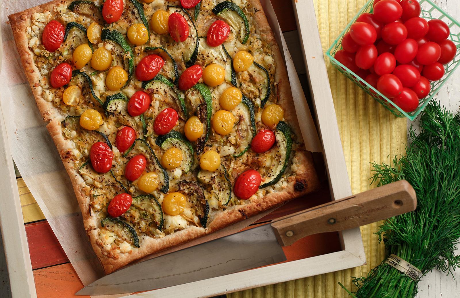 Ingredients for Lentil and Vegetable Tomato-Zucchini Bake laid out on a wooden table