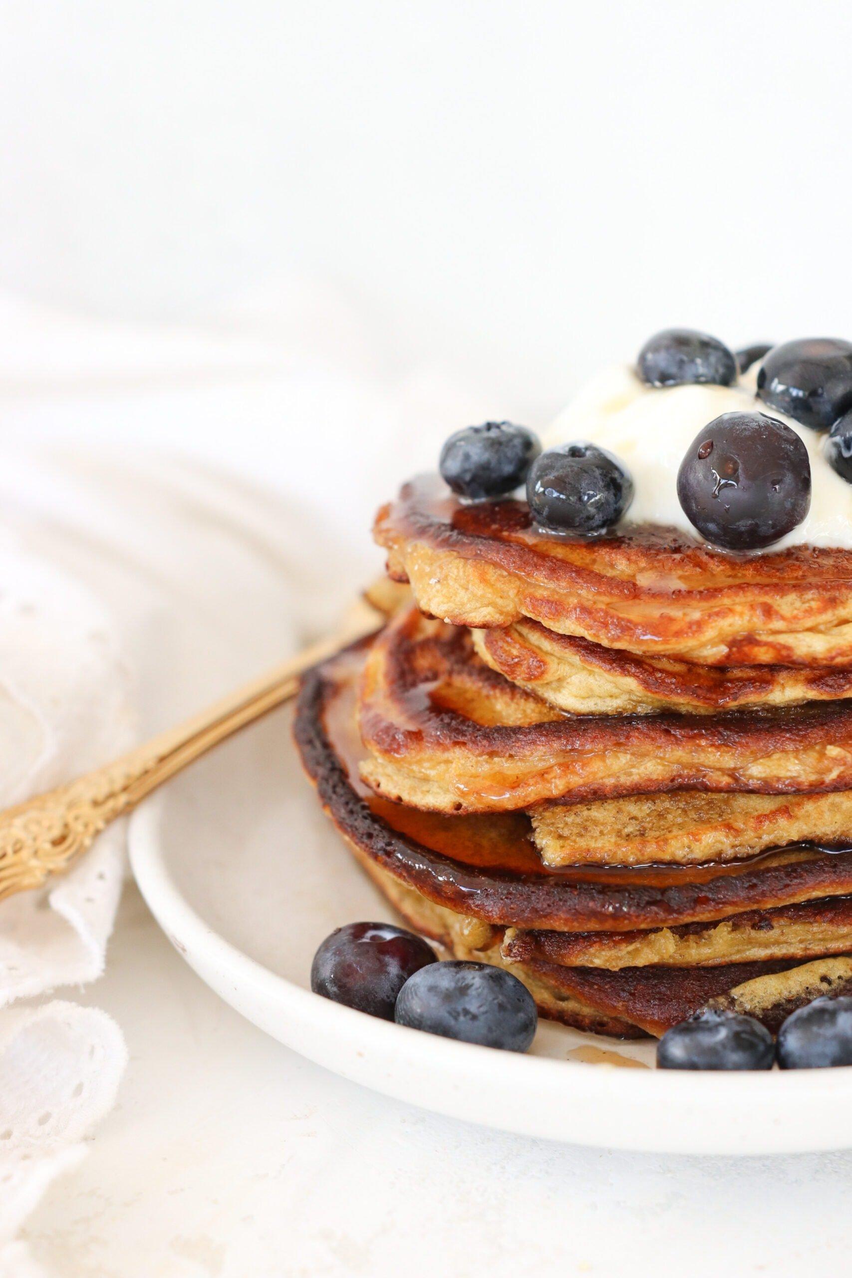 cottage cheese protein pancakes topped with berries and syrup
