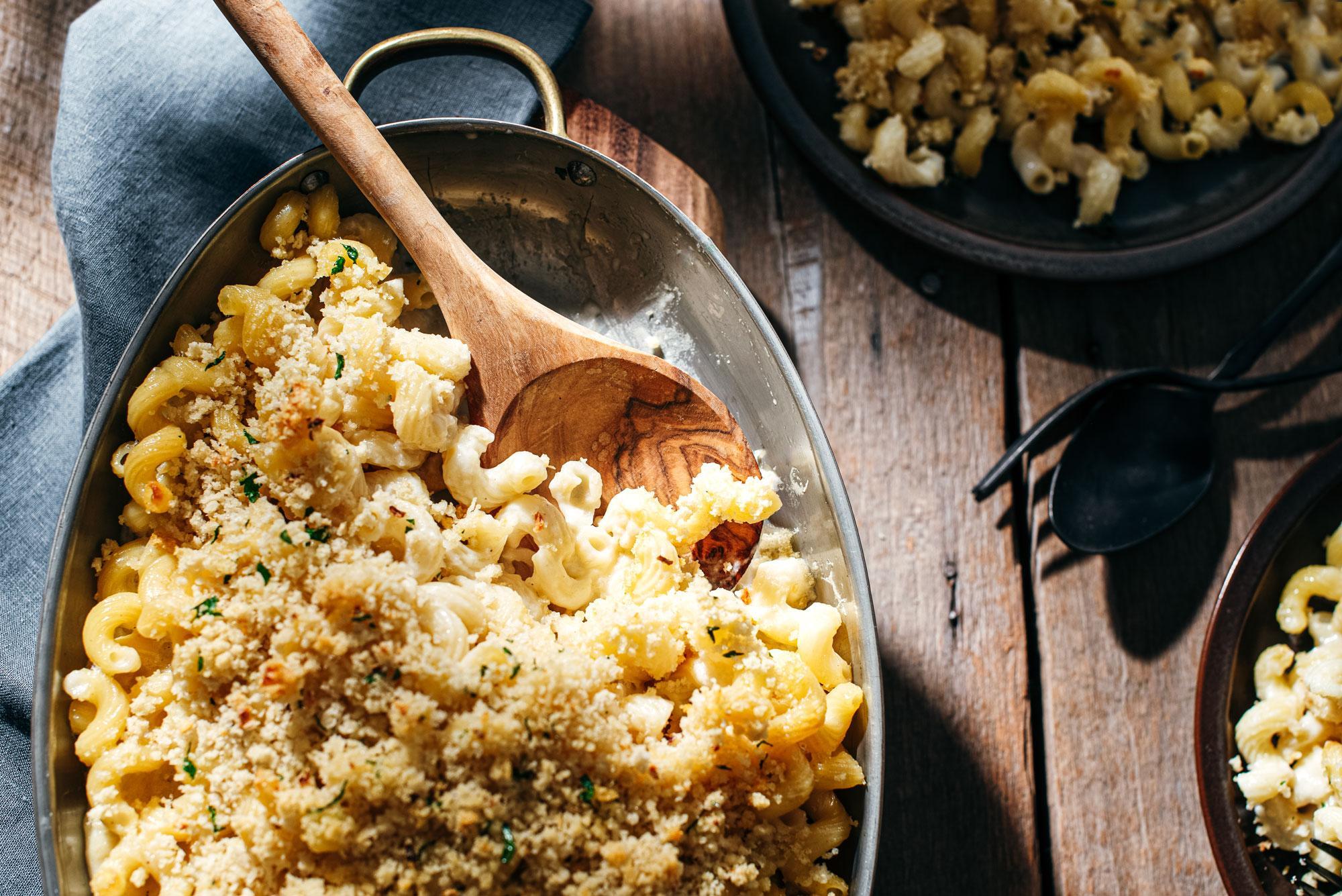 comforting bowl of baked mac and cheese on a rustic wooden table, cozy setting