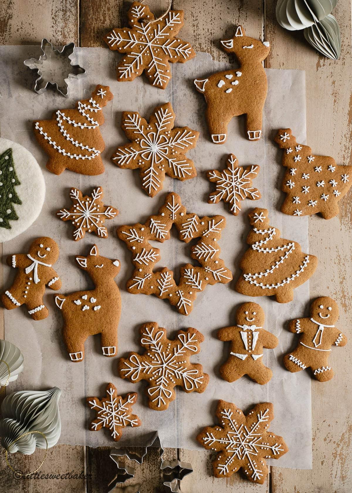 array of traditional gingerbread cookie cutters on a wooden board