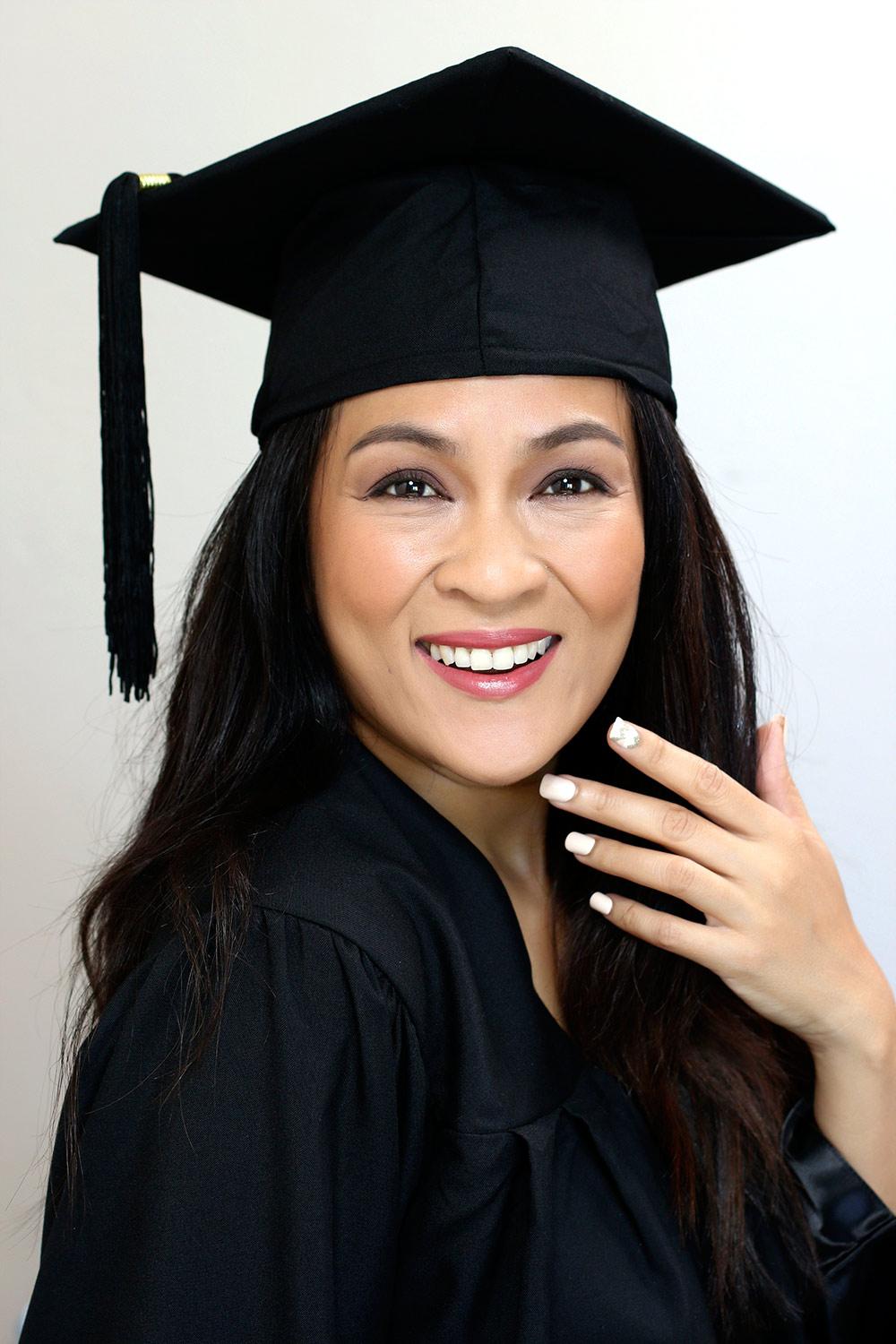 woman celebrating graduation with perfect nails
