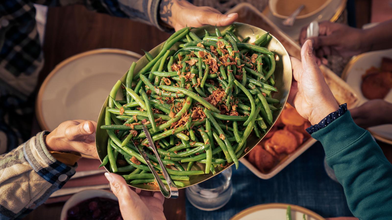person enthusiastically eating crispy green beans