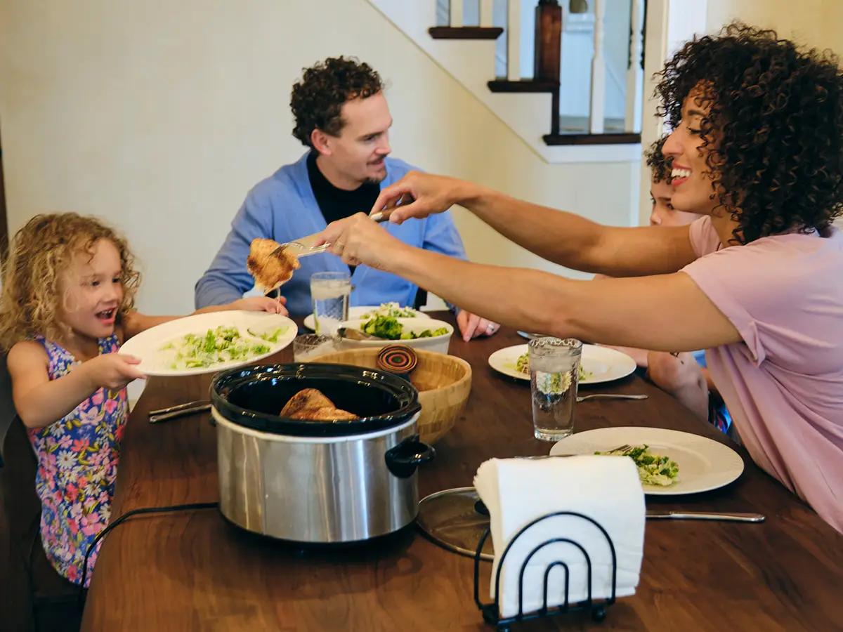 family enjoying a healthy crockpot dinner