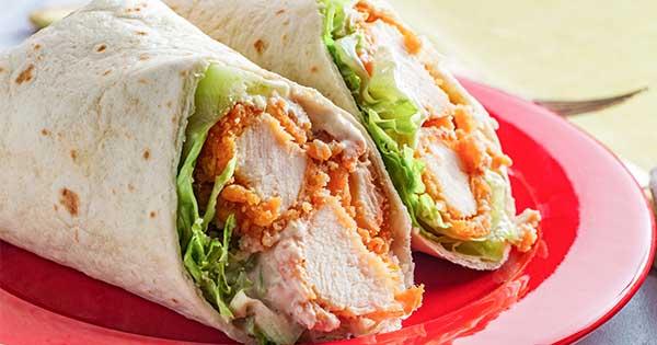Kids enjoying crispy chicken and mozzarella wraps for lunch