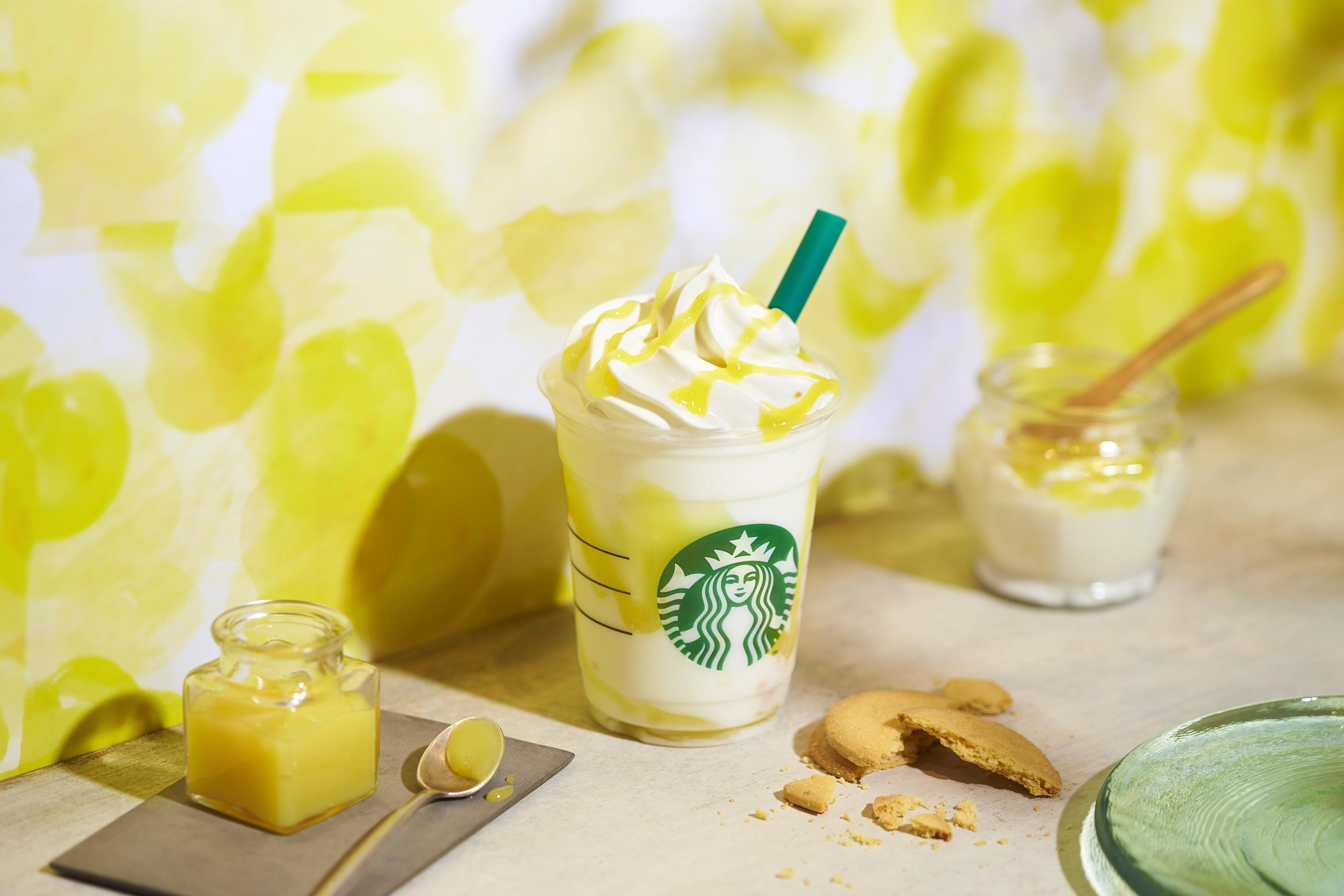 a person enjoying a yogurt frappuccino outdoors on a sunny day