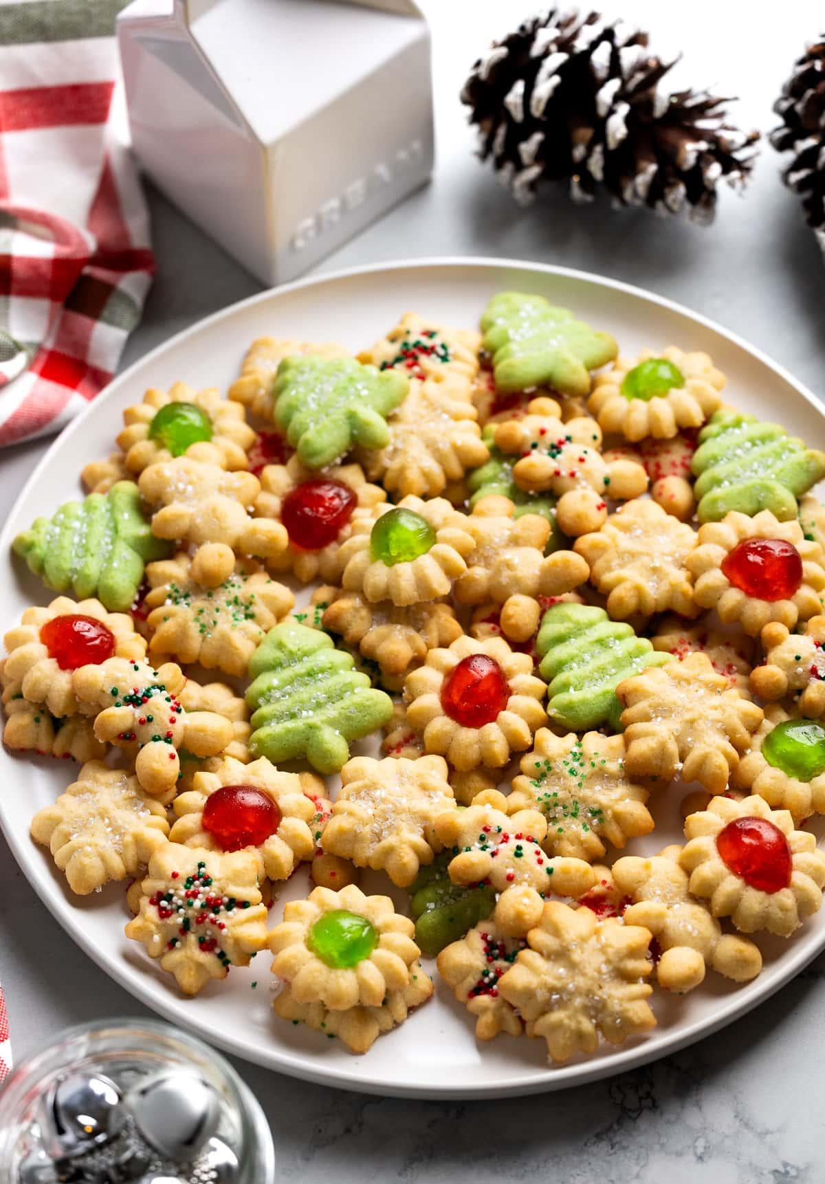 Assortment of decorated butter spritz cookies on a festive holiday platter