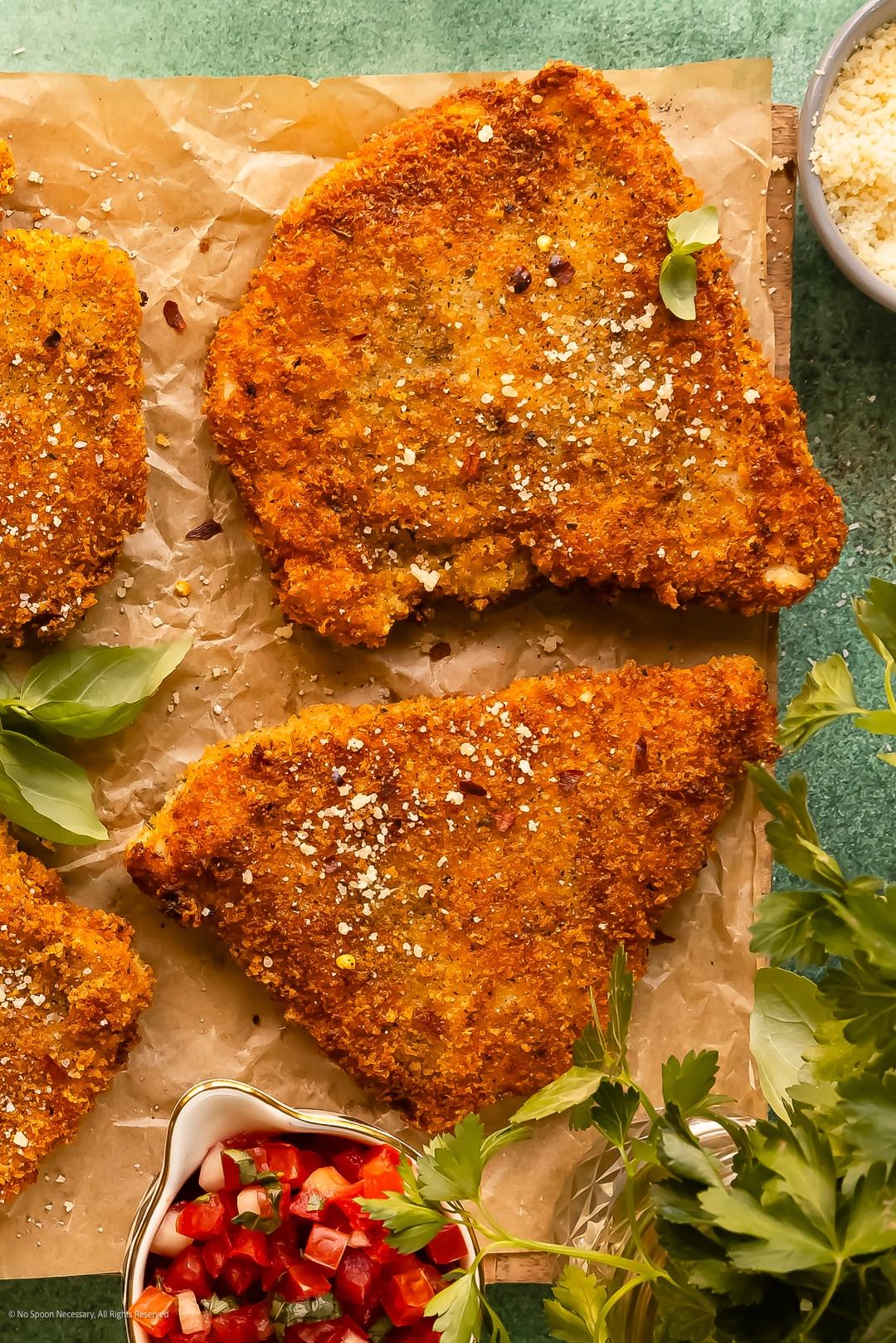 Golden-fried crispy parmesan chicken cutlet close-up