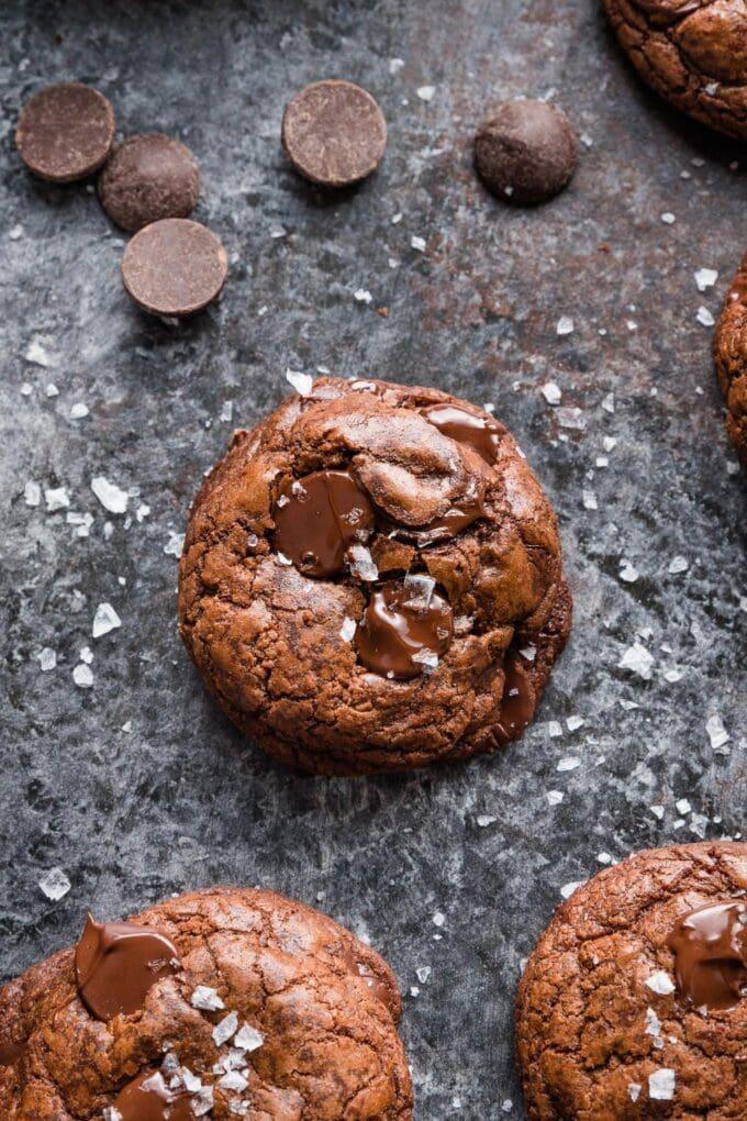close up of a dark chocolate sea salt cookie with visible salt flakes