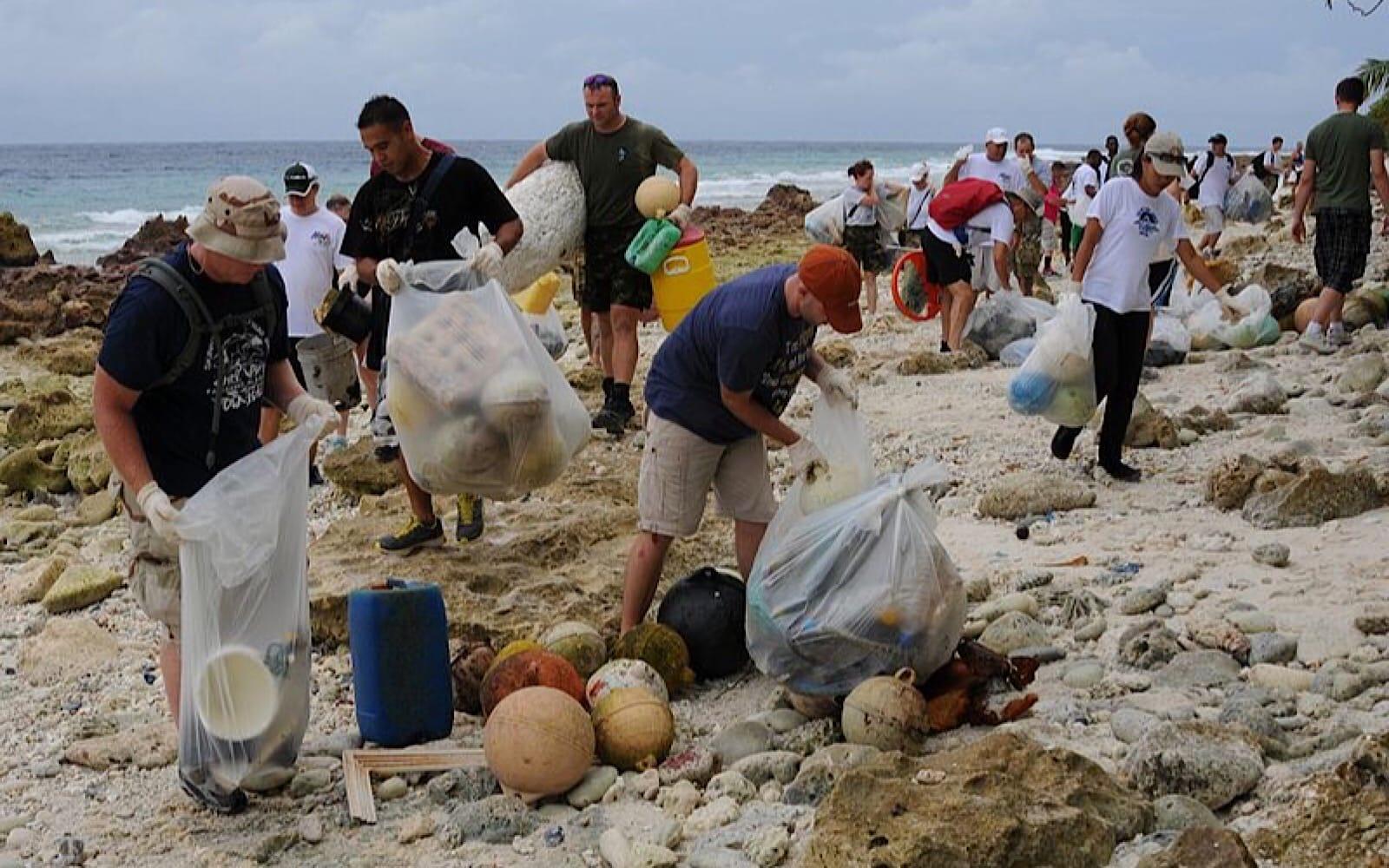 people cleaning up a beach after party