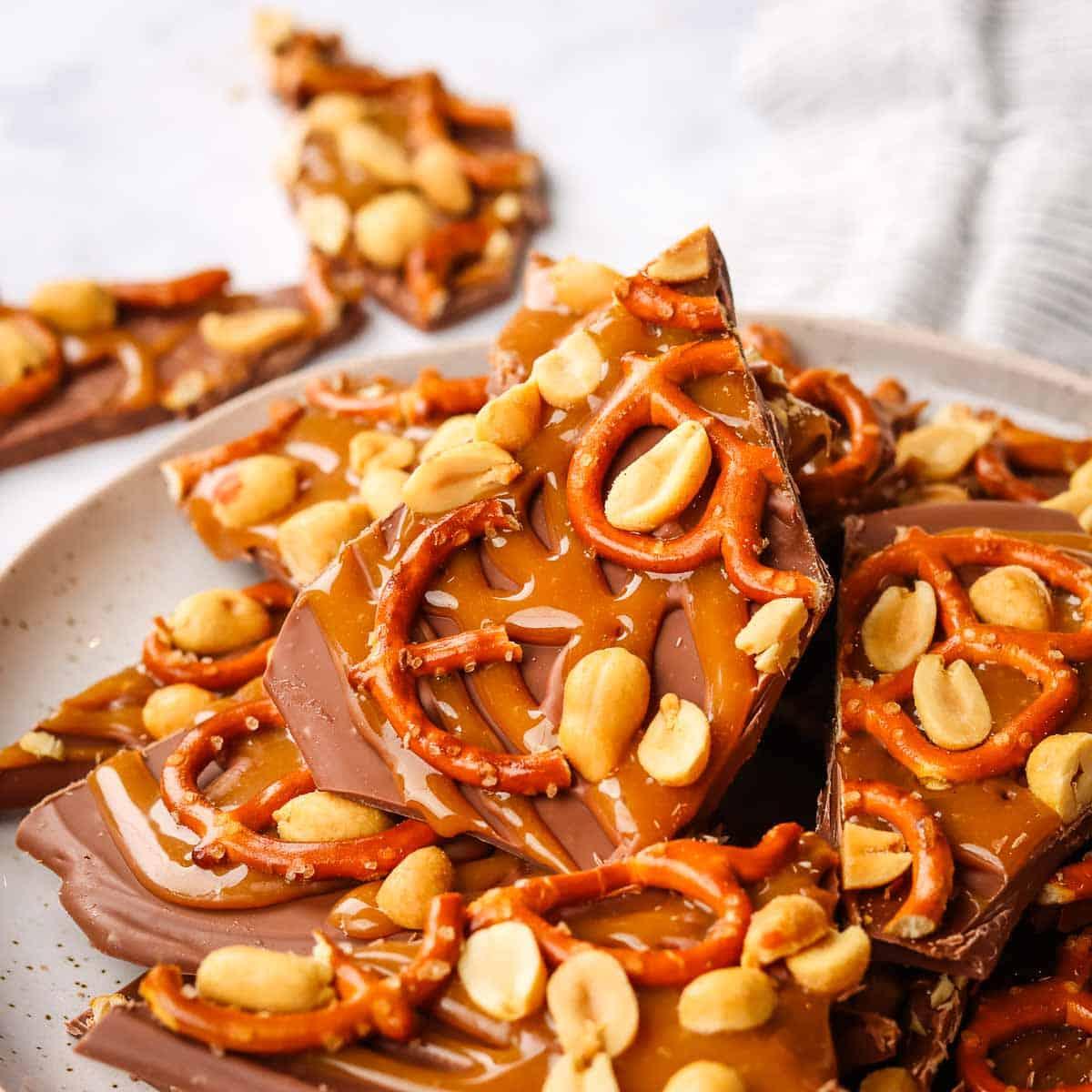 close-up of partially set swirled chocolate bark with various toppings like nuts, dried berries, and sprinkles