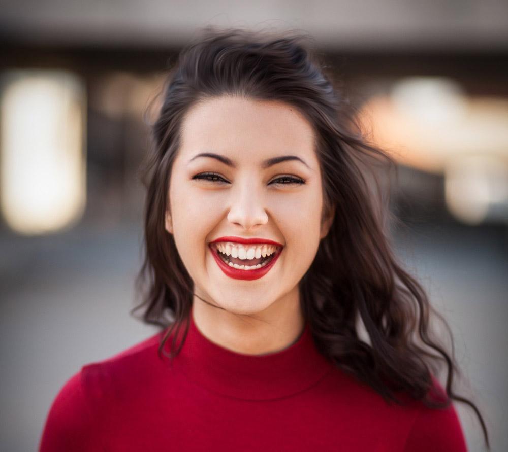 a young woman with bold red lipstick at an after-prom party