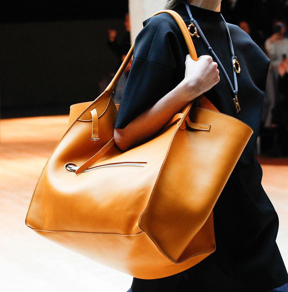 woman struggling to organize an oversized handbag