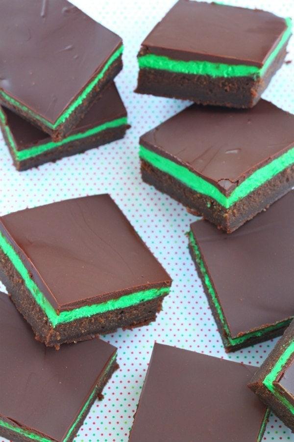 close up of a single mint chocolate square with visible layers, on a small dessert plate