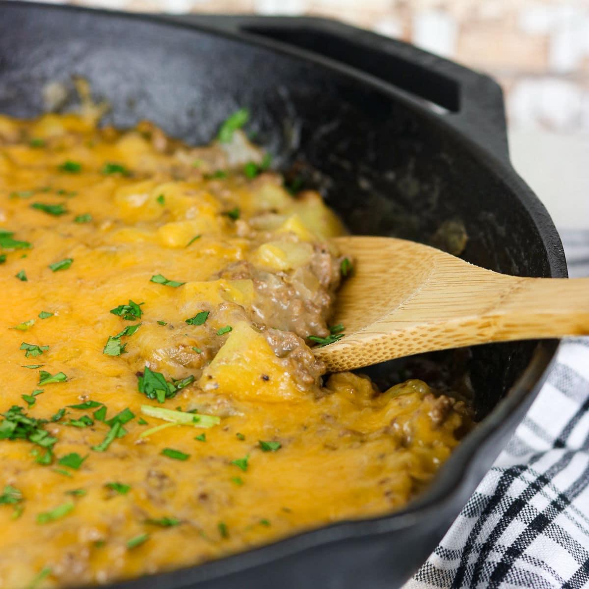 close-up of chipotle cream sauce simmering in a skillet with ground beef