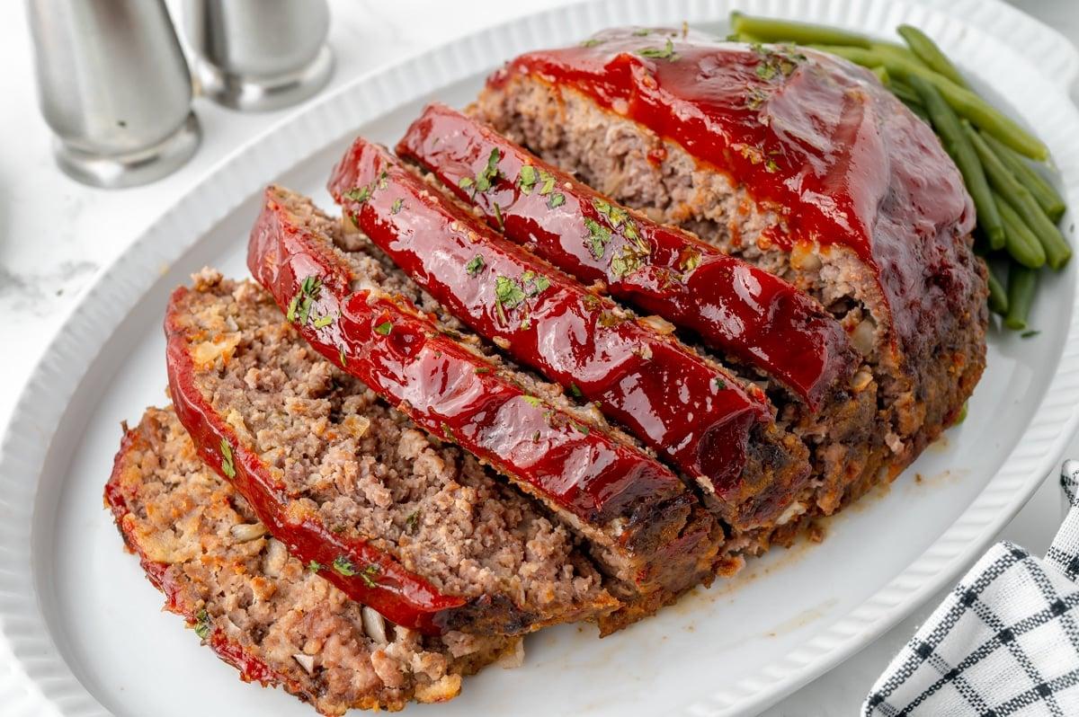 meatloaf being sliced, steam rising