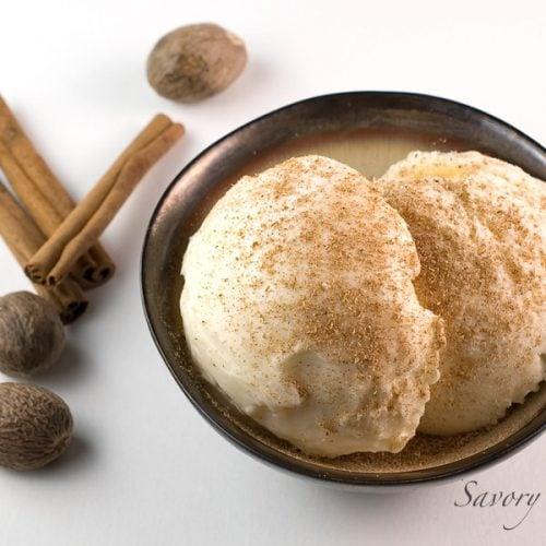 bowls of eggnog frozen yogurt with cinnamon sticks and nutmeg