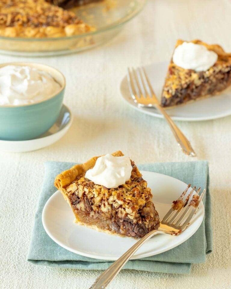 baking pie crust in a glass pie dish, raw pecans and chocolate chips on the side