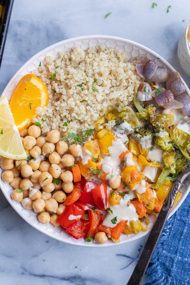 Colorful healthy rainbow dinner bowl with quinoa, roasted vegetables, and chickpeas