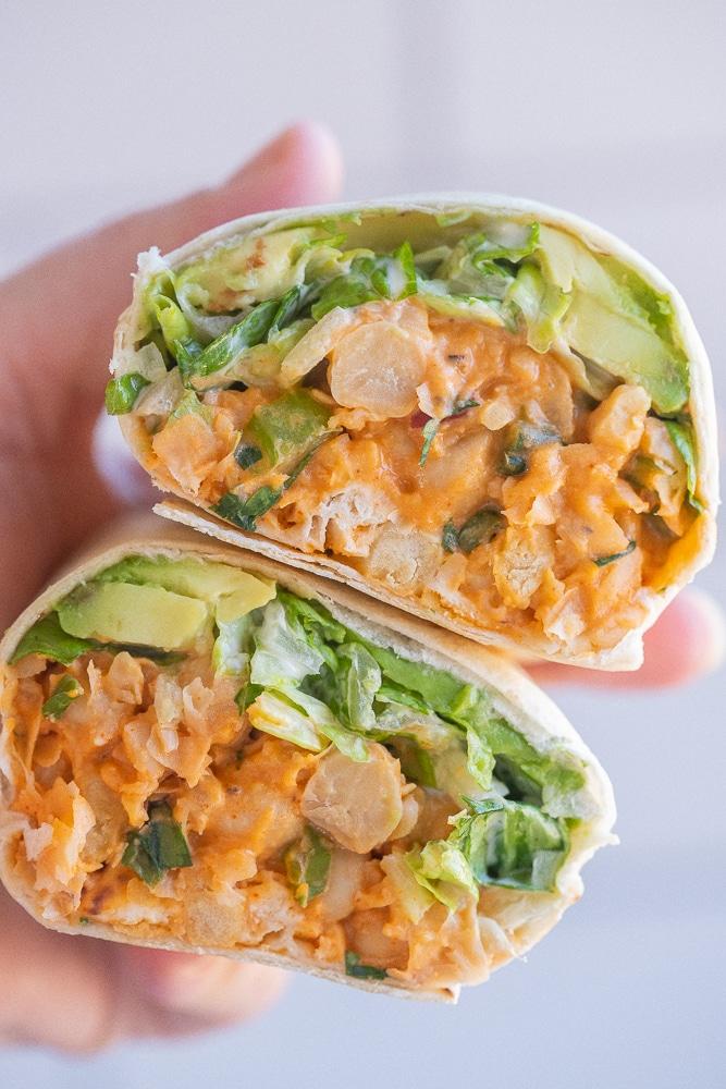buffalo chickpea wraps cut in half, showing the filling