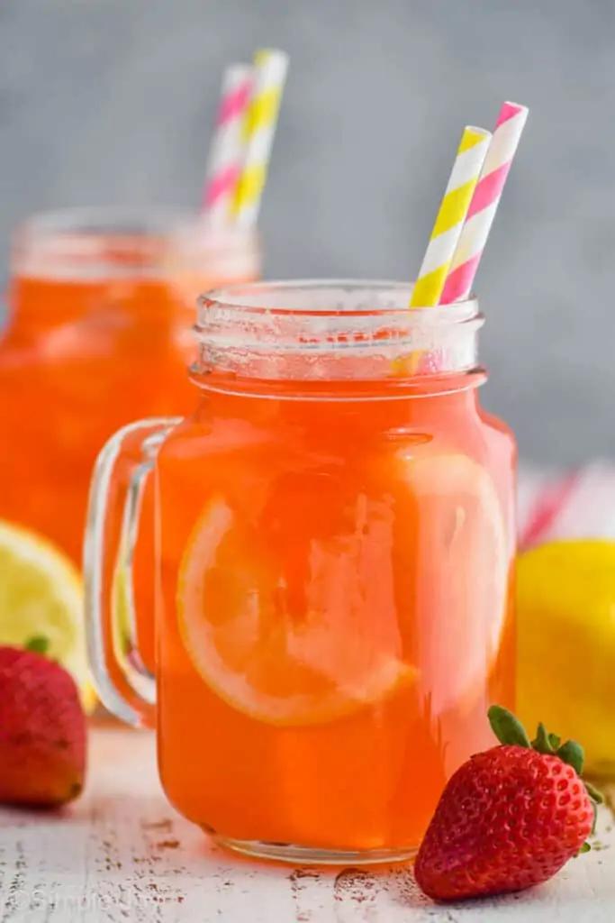 a person enjoying a strawberry lemonade dreamsicle smoothie outdoors in the sunlight