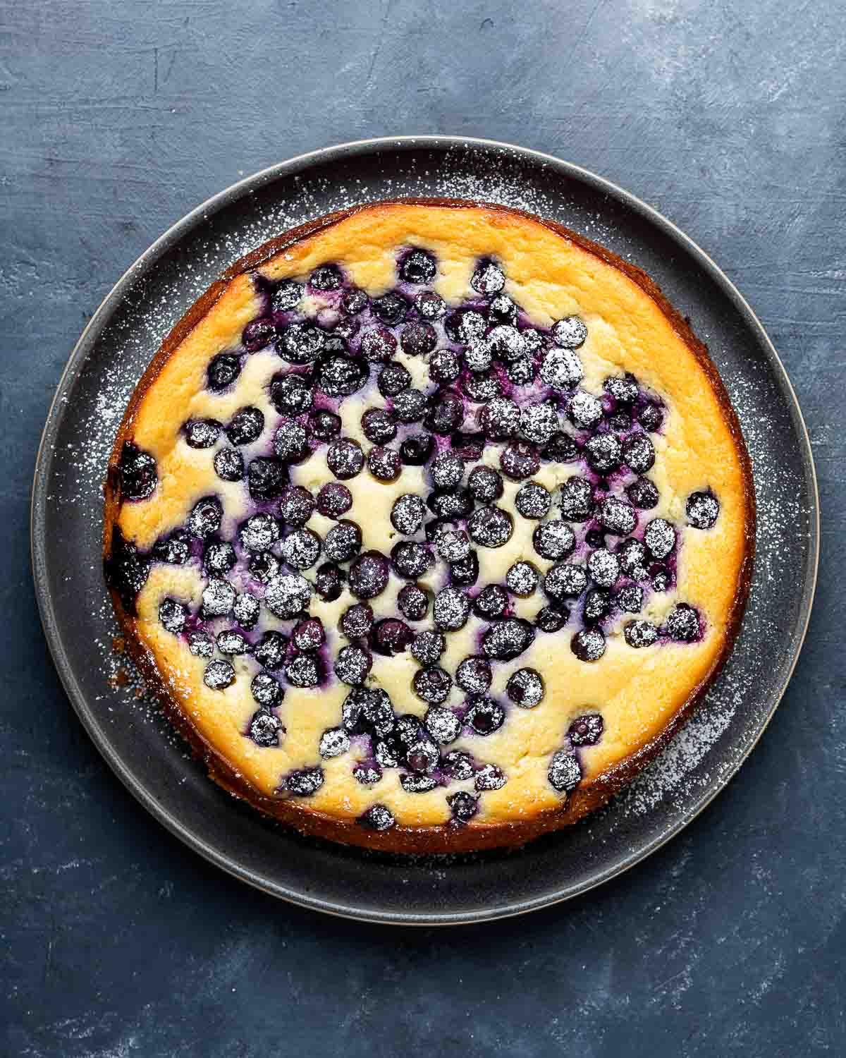 overhead shot of a slice of lemon ricotta blueberry breakfast bake being served