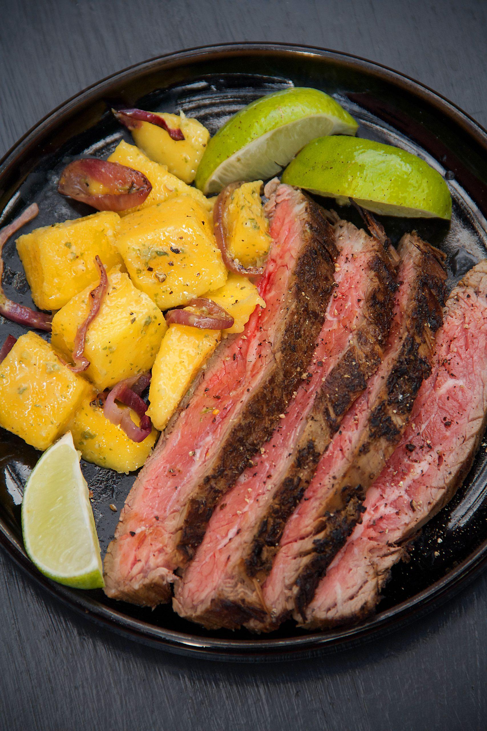 raw steak marinating in mojo sauce