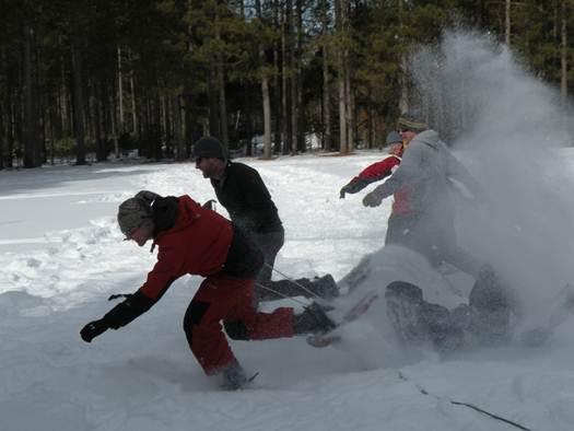 person falling in the snow while snowshoeing