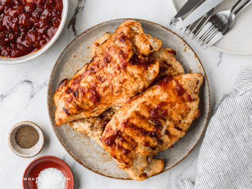 Cranberry barbecue chicken on a grill, close-up