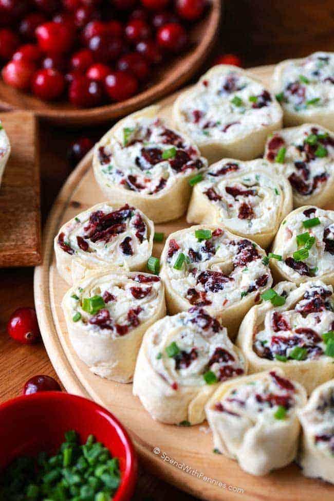 Holiday Cranberry Feta Pinwheels platter with festive decorations and a cozy background