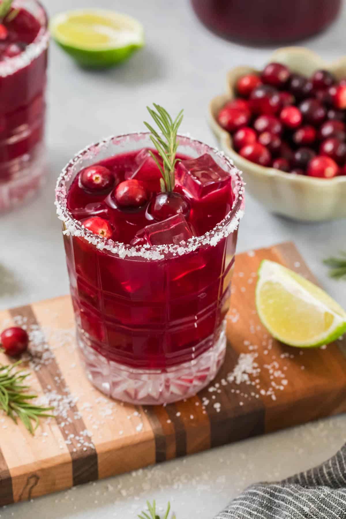 vibrant sparkling cranberry drink with fresh cranberries and rosemary garnish in a festive setting, Friendsgiving table