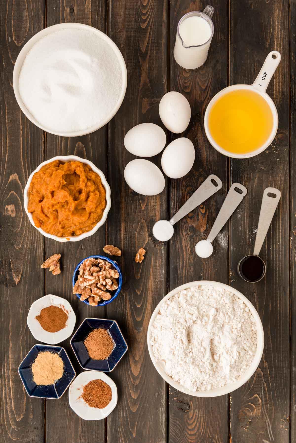 Ingredients for pumpkin bread on a wooden table