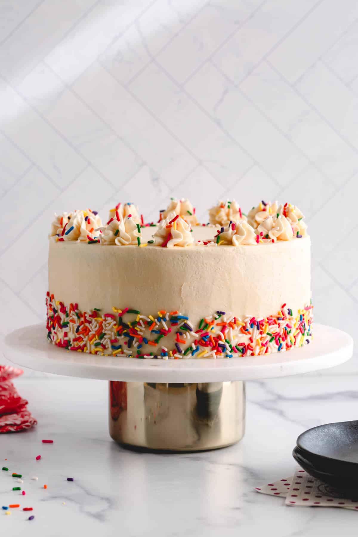 vanilla birthday cake with nigella seeds and white frosting