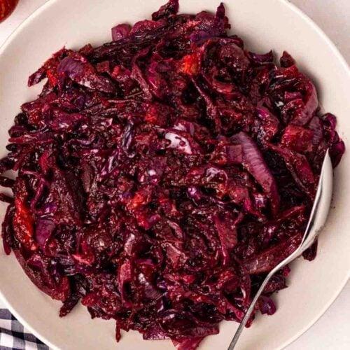 Close-up of braised red cabbage with steam and a fork
